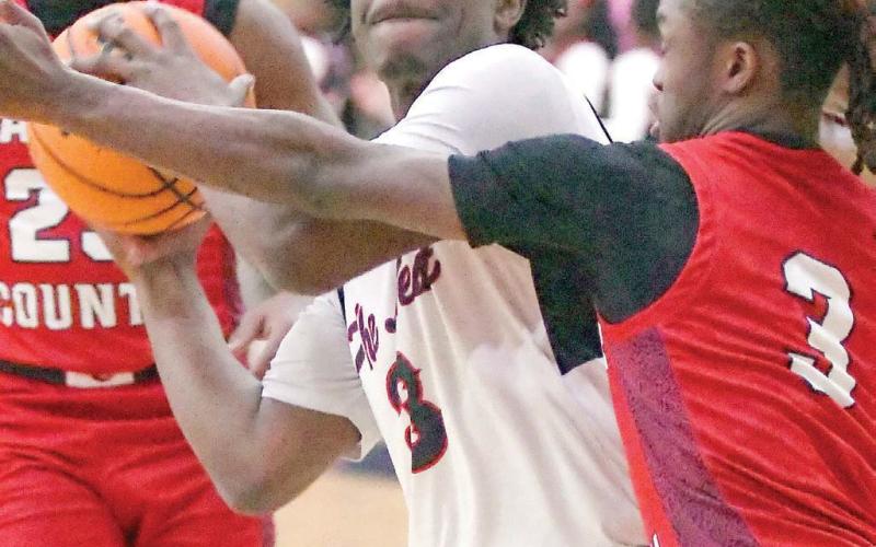 Putnam County senior Jmari Greene (3) gets set to attempt a layup over a defender. IAN TOCHER/Staff