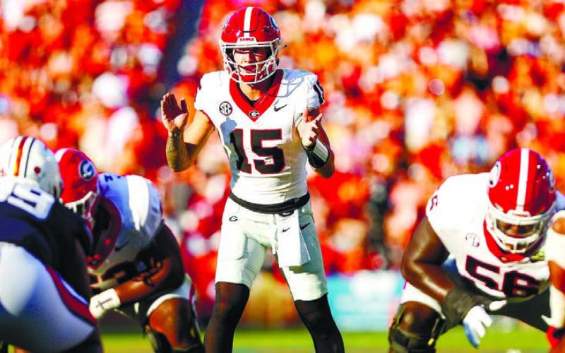 Georgia quarterback Carson Beck (15) calls for the snap in a close win over Auburn, in which he threw for 318 yards and a score. COURTESY OF UGA ATHLETICS