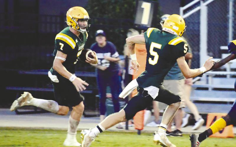 Fellow Gatewood seniors Evan Bennett (7) and Blake Callaway (5) each scored two touchdowns in the Gators’ 35-0 win over the Trinity Christian Crusaders Friday night in Dublin. IAN TOCHER/Staff