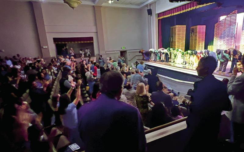 L-R: Jenny and Larry Moore with Rebecca Walker and her wife join a standing ovation as the cast of “The Color Purple” take a bow on The Plaza Arts Center stage. IAN TOCHER/Staff
