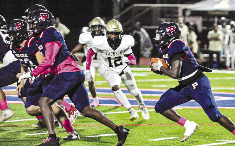 Rashod Daniel (3) carries the ball behind blockers in a game against Thomson on Oct. 20. CHARLES JORDAN/Staff