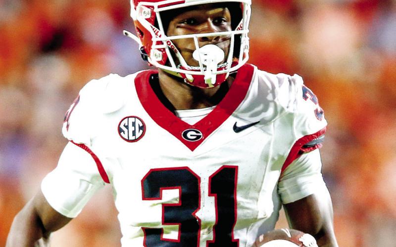 Georgia defensive back Kyron Jones (31) races toward the opposite end zone after recovering a fumble by Auburn quarterback Jackson Arnold. LANCE McCURLEY/Staff
