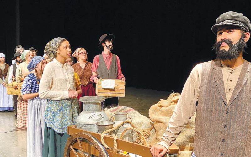 Tevye (David Trice) and the rest of the villagers leave their village. CONTRIBUTED