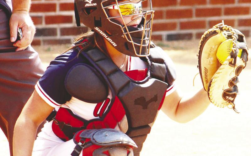 Addison Hutsell catches behind the plate for Putnam County. ARELLA CASH/Staff