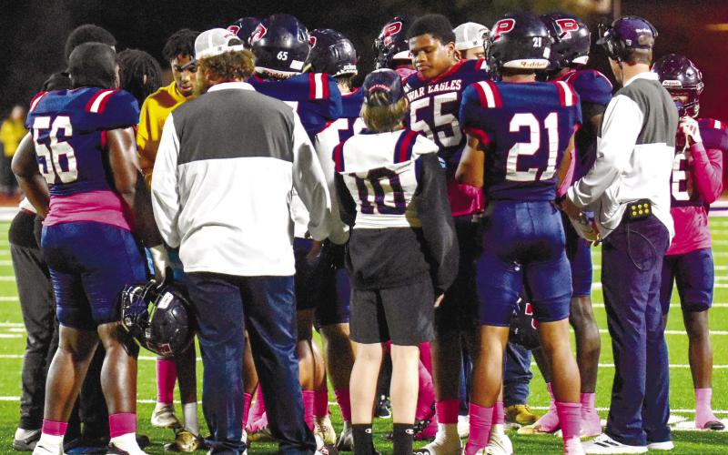 Putnam County players discuss the game plan during a timeout against Thomson on Oct. 20. CHARLES JORDAN/Staff