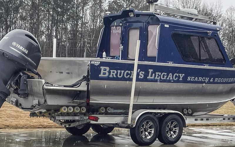 The Bruce’s Legacy boat is parked in the rain after owner Keith Cormican used it to locate the drowned body of Gary Jones on Lake Oconee. LYNN HOBBS/Staff