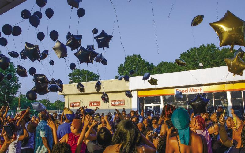 More than 100 people gathered to release memorial balloons last Friday night outside a Shell station in Eatonton where Frederick Scott Jr. was murdered June 4, in a broad-daylight shooting.