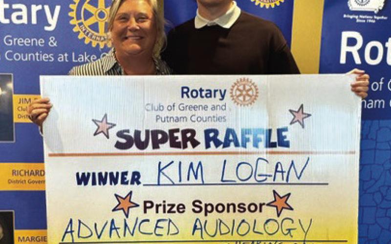 Rotarian and Rotary Area Governor Jennifer Pennington was joined by Rotary GRSP student Camilo Pareja of Columbia in presenting to Rotary Raffle Week 39 winner Kim Logan, who was not available for the photo, a pair of Apple AirPods and a fourpack of Apple AirTags valued at $350 total and sponsored by Advanced Audiology. CONTRIBUTED