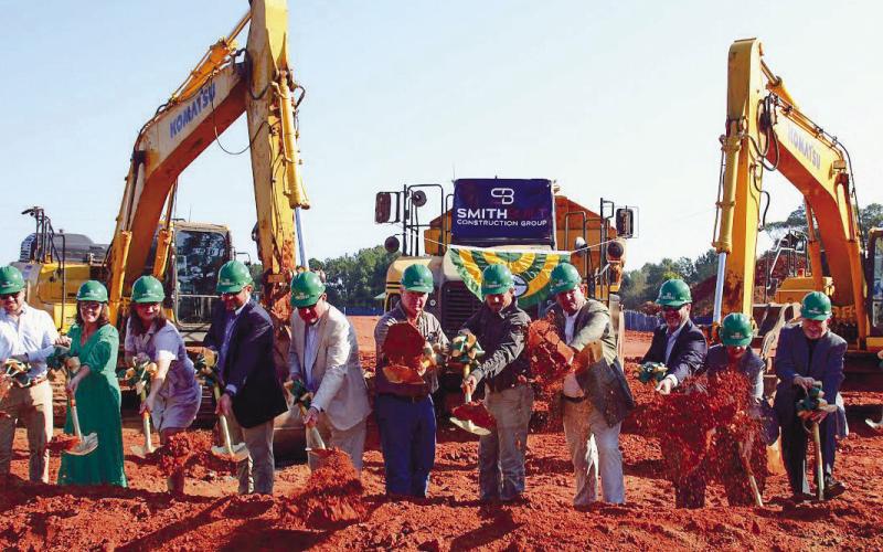 Representatives of Gatewood Schools, including Headmaster Jeff Decker, Assistant Headmaster Josh Ringer and Director of Development Marie Rainey, among others, joined several local officials in tossing a ceremonial shovelful of dirt for the official groundbreaking of Gatewood’s new high school. IAN TOCHER/Staff