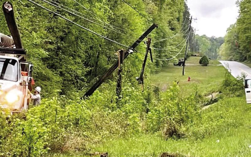 Tri County EMC linemen repair downed lines on Twin Bridges Road. PHOTO CONTRIBUTED