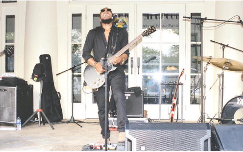 At least one happy couple outwaited the wet stuff to share a dance to the sounds of Cash’s Juke Joint, playing Saturday afternoon on the steps of The Plaza Arts Center in Eatonton.
