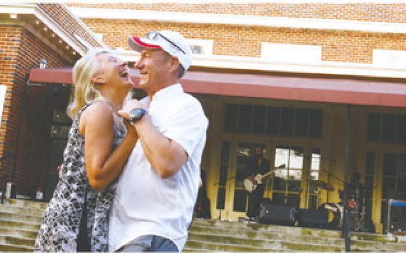At least one happy couple outwaited the wet stuff to share a dance to the sounds of Cash’s Juke Joint, playing Saturday afternoon on the steps of The Plaza Arts Center in Eatonton.