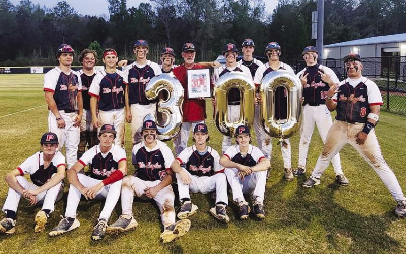 Following a 7-4 decision over Jasper County on March 31, War Eagles head baseball coach Stephen Phillips (in red) shared his accomplishment of reaching 300 career wins with his current team and family members. CONTRIBUTED