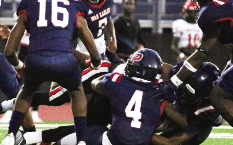 Several Putnam County defenders, including Braxston Mays (4) and Kaleb Lawrence, bring down a McNair ball carrier in last Friday’s win. LANCE McCURLEY/Staff