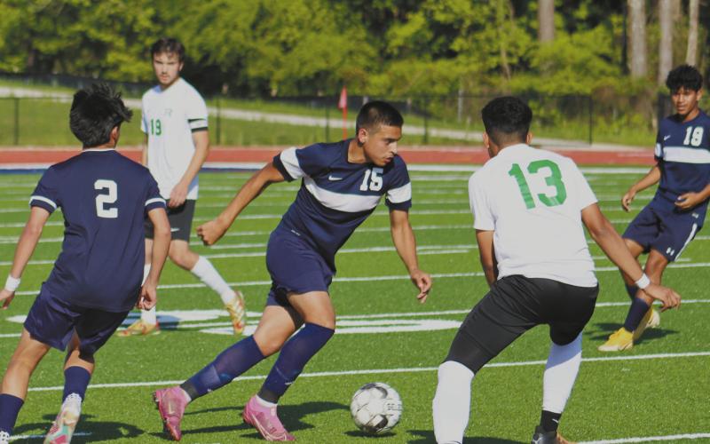 Emmanuel Meraz (12) dribbles through Rutland defenders. ARELLA CASH/Staff