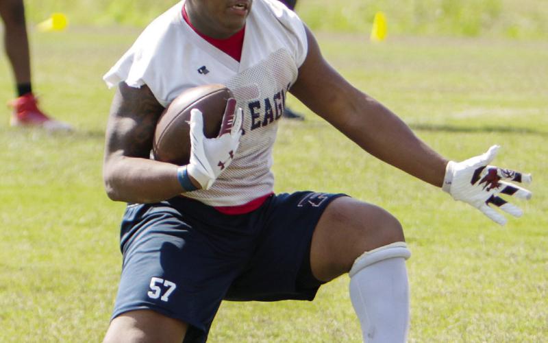 Putnam County junior running back Elijah Dunn goes through a drill during a spring practice in May. LANCE McCURLEY/Staff
