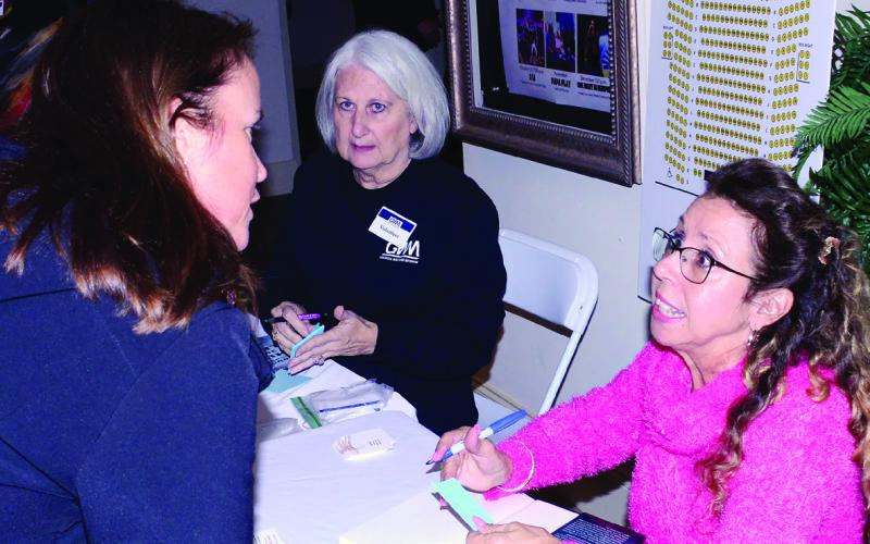 Following her presentation, author Kathy Kleiner-Rubin met attendees in the lobby to chat and sign copies of her book, “A Light in the Dark: Surviving More Than Ted Bundy.” IAN TOCHER/Staff