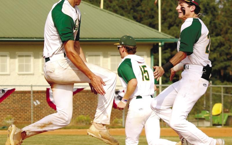 A high-flying Walker Roberts (3) and Tanner Johnson (24) celebrate advancing to the state playoffs after ousting TREY NORRIS/Staff