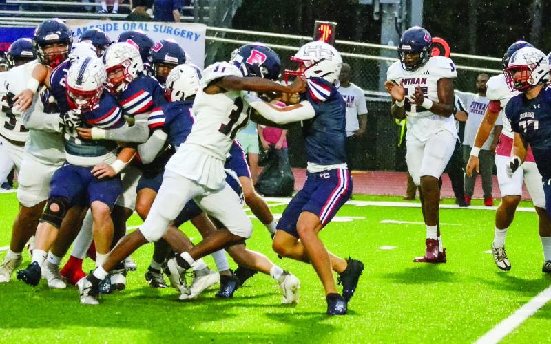 Neither team managed much offense in the first quarter as both coaches tried to run inside the tackles due to the slippery field. (T. MICHAEL STONE/Staff)