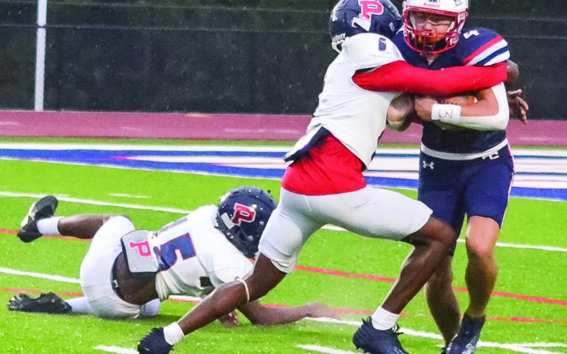 Don Dorsey brings down the Haralson County kick returner inside the 15-yard line. (T. MICHAEL STONE/Staff)