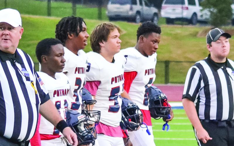 Putnam County's team captains head to midfield for the coin toss. (T. MICHAEL STONE/Staff)