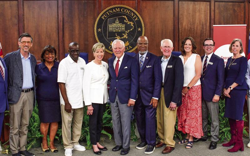 Members of Georgia Humanities posed with panelists Cathy Cox, Gov. Nathan Deal, and Legislator Calvin Smyre shortly before their discussion on democracy and the current condition of state and federal politics took place. IAN TOCHER/Staff
