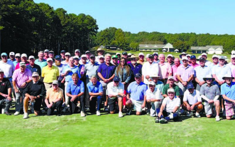 Jennifer Vaughan of Ansley Real Estate Christie’s International (center) is surrounded by the entire playing field for the Georgia Senior PGA at Reynolds Lake. CONTRIBUTED