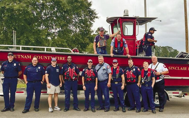 Putnam County Fire Department personnel smile proudly in front of their new fire rescue boat before taking it out on the lake for training. CONTRIBUTED
