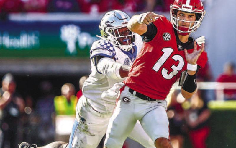 Quarterback Stetson Bennett (13) went 14-20 passing in 2021 against Kentucky for 250 yards and three touchdowns with no interceptions for an average of 12.5 yards per play. He also rushed three times for 22 yards. TONY WALSH/UGA Athletics
