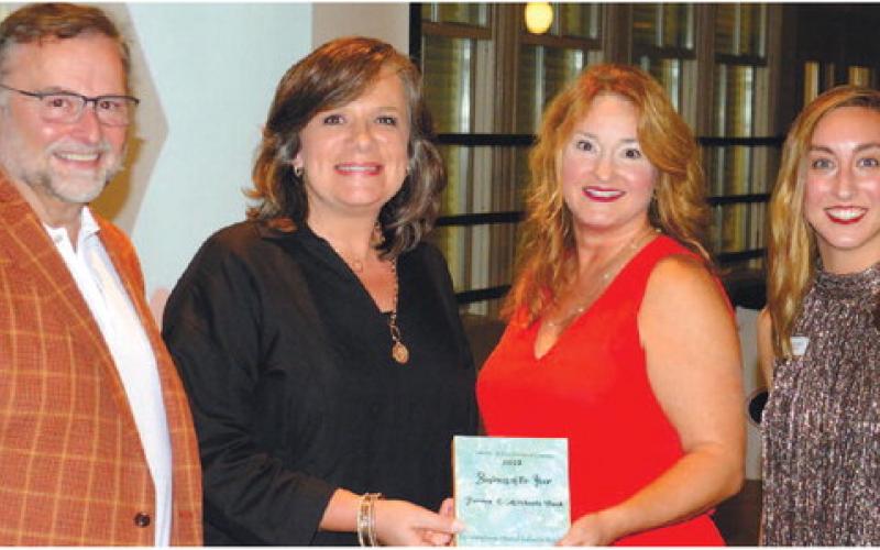 L-R: Chuck Haley, president of The Peoples Bank, Linda Moore and Amy McElhaney, both of Farmers &amp;amp; Merchants Bank, and Chamber of Commerce President and CEO Maggie Milner celebrate Farmers &amp;amp; Merchants Bank being named 2022 Business of the Year for Eatonton-Putnam County. IAN TOCHER/Staff