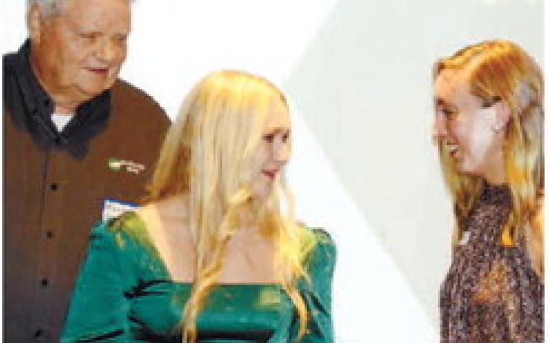 Tri-County EMC’s “Buck” Comer looks on as Youth in Excellence winner Karlie Horton speaks with Chamber President Maggie Milner. IAN TOCHER/Staff