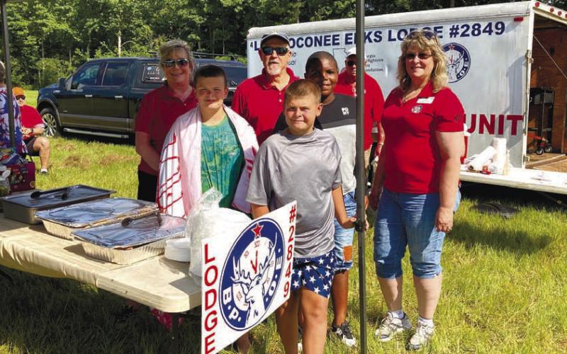 CONTRIBUTED PHOTOS The Lake Oconee Elks Lodge brought the chuck wagon to the boys and girls in the Greene County 4H Club for a fun day of hot dogs and slip-and-slide water fun. Pictured are, back row: Jodie Haynes, Harry Russell, Brandon Benbow, Bubba Massey and Wendy Dill; front row: Jasper and Brock Copelan.