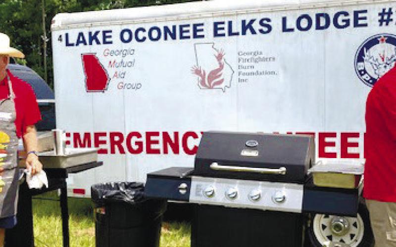 Bob Pluta (left) and Bubba Massey are the chefs grilling the hot dogs.