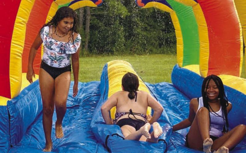 Kids having fun on the slip and slide.