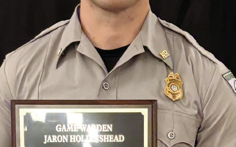 Game Warden Jaron Hollinshead poses with the 2024 Georgia Level Torch Award. (CONTRIBUTED)