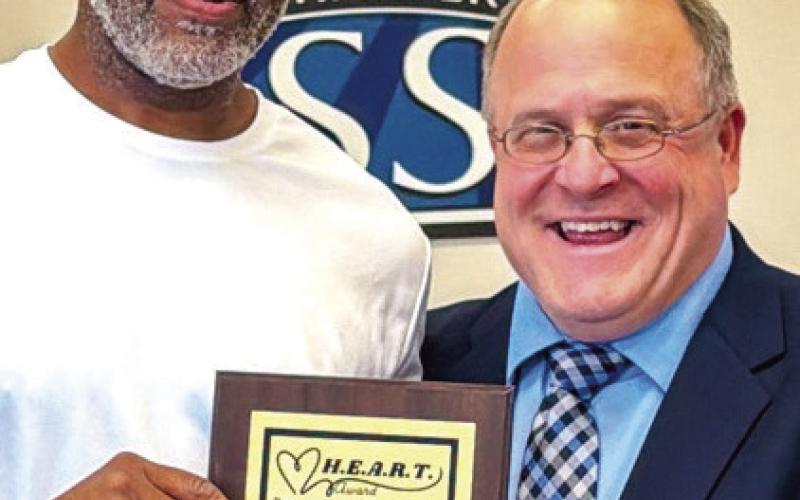 H.E.A.R.T Award recipient Larry Dunn poses with Assistant Superintendent Scott Sauls. ALIVIA BLANTON/Staff