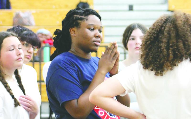 Former PCHS volleyball player and current assistant coach Amaya Banks talks to her players during a recent practice. ARELLA CASH/Staff