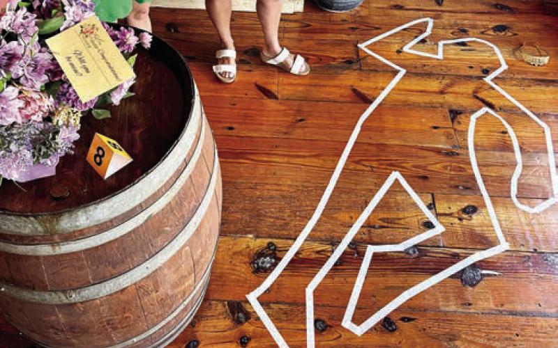 A taped outline at Eatonton’s Barrel 118 depicted the crime scene for the inaugural Eatonton Murder Mystery Shopping Crawl. CONTRIBUTED