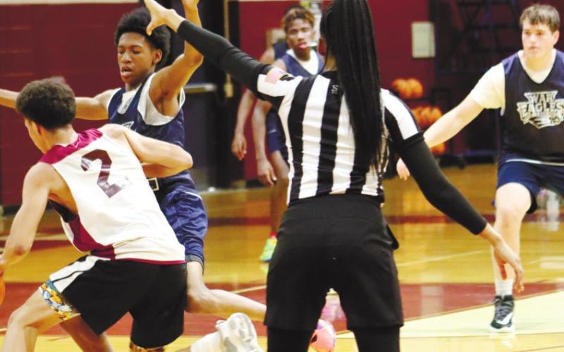 Kenyi Crawford applies strong defense along with Brixton Woodall. ARELLA CASH/Staff