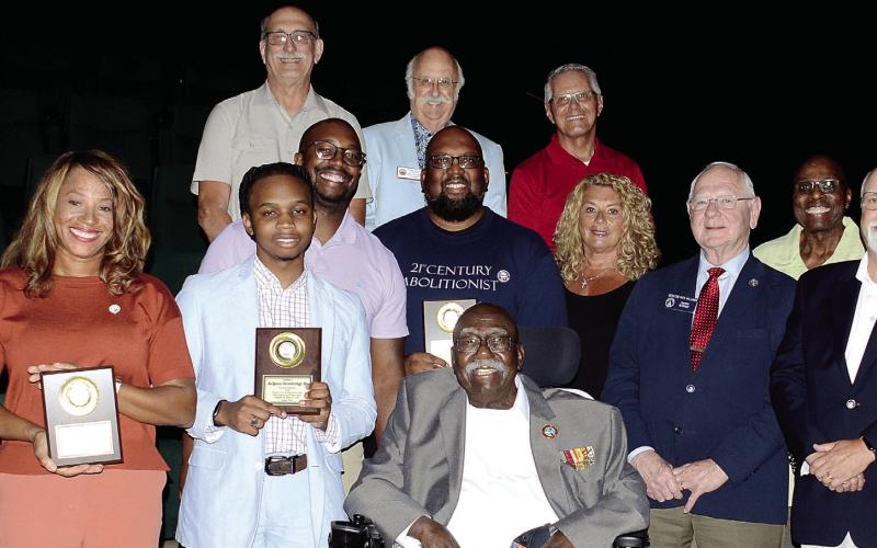 Charles Person (seated) is surrounded by each of the other speakers and several local politicians and community leaders Aug. 13, following his talk at the Putnam County Republican Party’s unique “When Blacks and Whites Work Together ...” event at Parkside Main Theater in Greensboro. IAN TOCHER/Staff