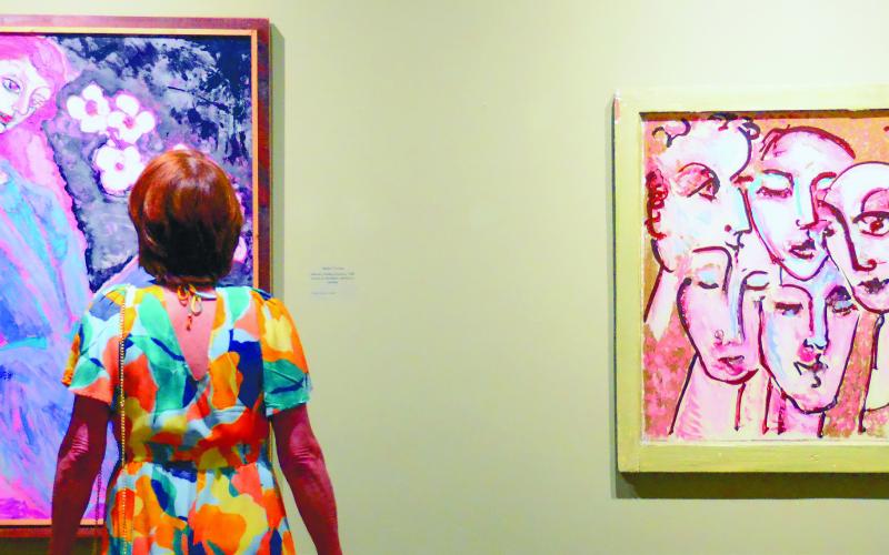 A Founder’s Day attendee examines reverse drawings created by Steffen Thomas. Supplies also were available to anyone interested in trying out the mind-bending art technique.