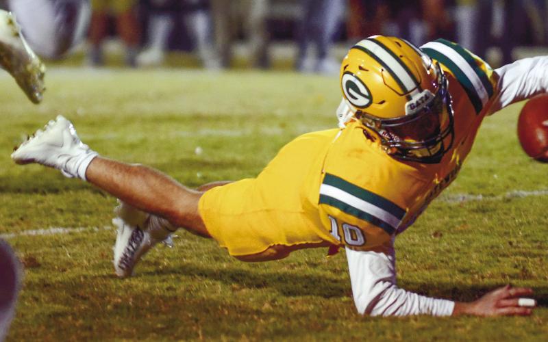 Gators quarterback Ames Johnson makes the extra effort to gain every bit of ground possible Friday night against Brentwood. IAN TOCHER/Staff