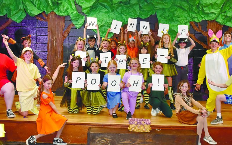 Gatewood Players show off the final scene of the play, holding up letters spelling out the name of the performance. LENA HENSLEY/Staff