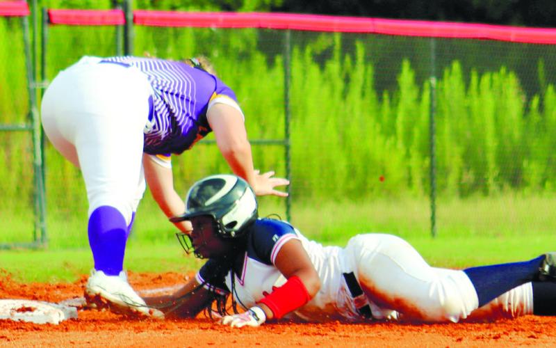 Taylor Eubanks dives to be safe at third base.