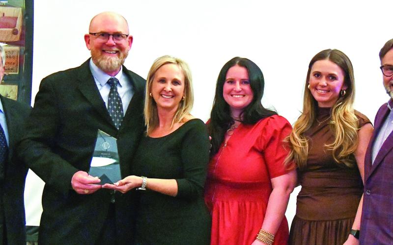 E-PCOC President Robbie King (far left) and Peoples Bank President Chuck Haley (far right) presented the 2026 Business of the Year Award to Keith Fitzgerald, founder and owner of ProSouth Services Electrical-Heating and Air, with his family. IAN TOCHER/Staff