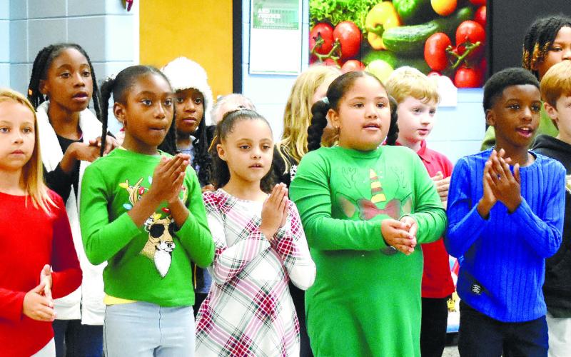 Third graders sing “We Wish You a Merry Christmas.” BAILEY McCULLY/Staff