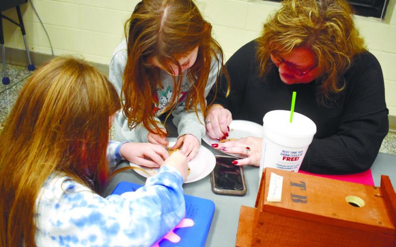Board member Carol Ann Guthrie participates in an archeological dig with two students from Roberts’ class. BAILEY McCULLY/Staff