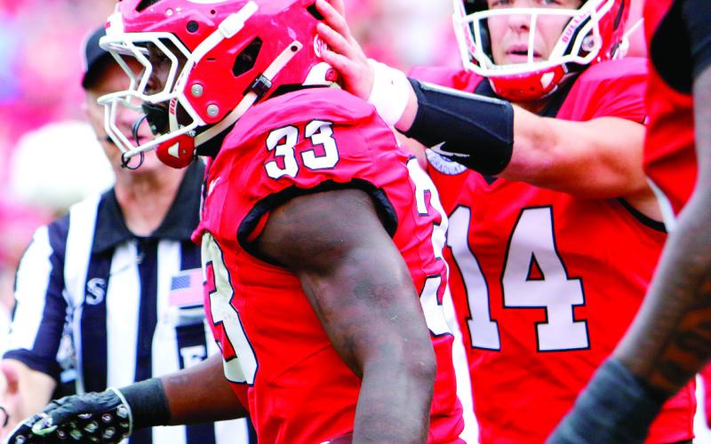 Georgia running back Chauncey Bowens (33) celebrates with teammates after scoring a touchdown against Austin Peay on Saturday. LANCE McCURLEY/Staff