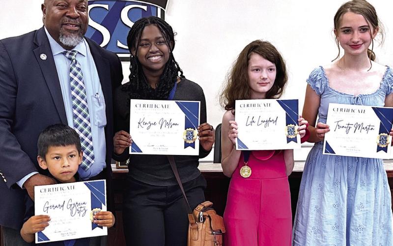 Putnam County Board of Education Superintendent Derick Austin recognized the Superintendent’s Students of the Month for May, including (l-r) Gerard Garcia Ortiz, Kenzie Nelson, Lila Langford, and Trinity Martin. ALIVIA BLANTON /Staff