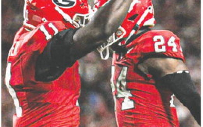 Sophomore linebacker Jalon Walker (11) and defensive back Malaki Starks celebrate during the win o ver UAB at Sanford Stadium. CHARLES JORDAN/Contributed